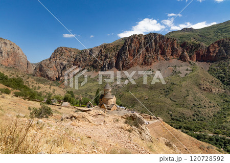 Explore the serene beauty of Noravank monastery amidst Armenias striking red mountains and lush landscapes Explore the serene beauty of Noravank monastery amidst Armenias striking red mountains and lush landscapes 120728592