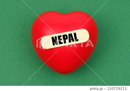 On a green surface lies a red heart with the inscription - Nepal 120729213
