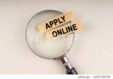 On the magnifying glass are paper strips with the inscription - APPLY ONLINE 120729250