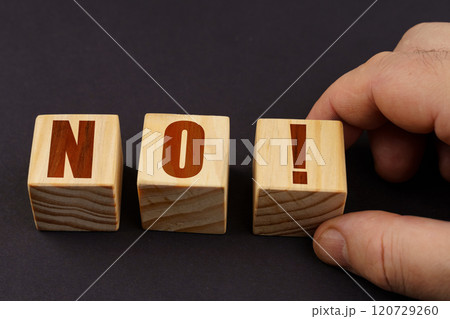 On a black surface, a man puts cubes with the inscription - NO 120729260