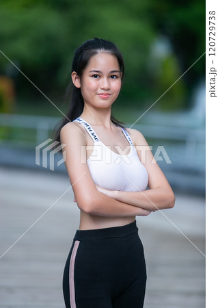 Portrait of fit woman sport wear pose arm cross looking to camera. Beautiful asian female strong activewear healthy body. Portrait of fit woman sport wear pose arm cross looking to camera. Beautiful asian female strong activewear healthy body. 120729738