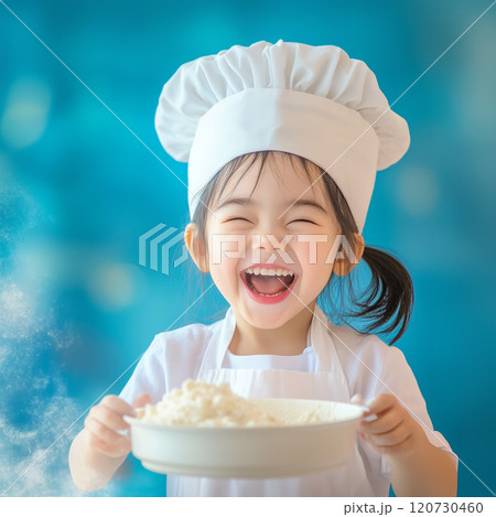 Cute young chef smiling while holding a bowl of flour 120730460