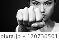 Strong determination shown through a clenched fist in a black and white portrait 120730501