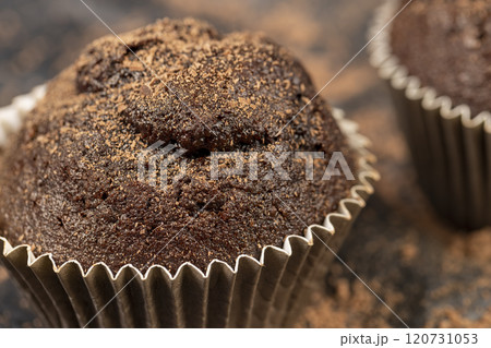 fresh and soft black chocolate cupcake on black paper fresh and soft black chocolate cupcake on black paper 120731053