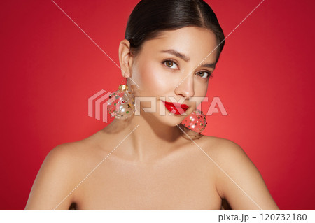 Portrait of beautiful young woman on red background 120732180