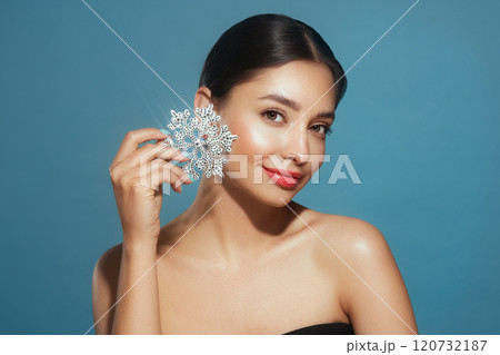 Beautiful young woman with glowing snowflake Beautiful young woman with glowing snowflake 120732187