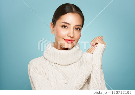 Young beautiful woman in a warm  white sweater 120732193