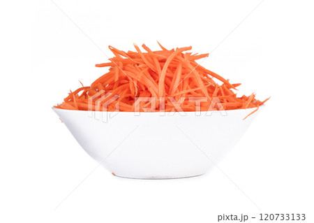 Carrots cut into thin strips as an ingredient for different dishes in a bowl on a white background. Carrots cut into thin strips as an ingredient for different dishes in a bowl on a white background. 120733133