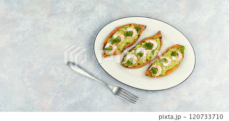 Baked sweet potato with shrimp in plate on table. 120733710