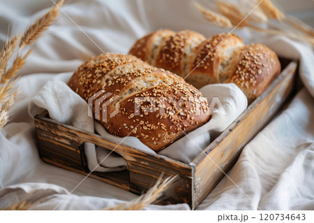 Freshly baked bread with sesame seeds in a wooden box. 120734643