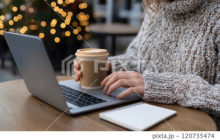 Woman using laptop with coffee in a cafe 120735474