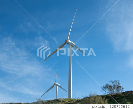 Wind turbines on agricultural land in Andalusia, Spain. 120735613
