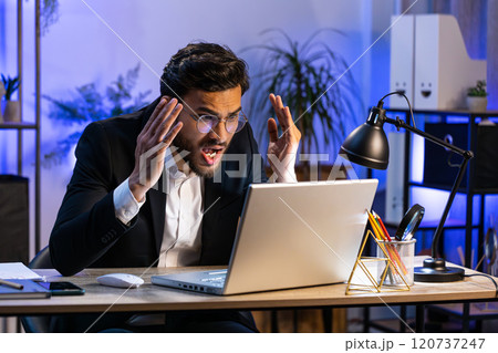 Irritated tired businessman working on laptop website problem, computer virus data loss by hacking 120737247