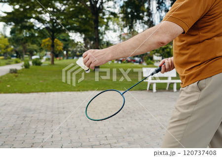 Senior Man Playing Badminton Outdoors Senior Man Playing Badminton Outdoors 120737408