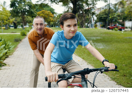 Boy Riding A Bike In The Park 120737445