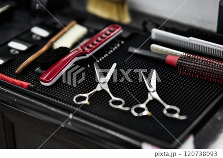Tools for grooming prepared on a work surface in a barbershop setting 120738093