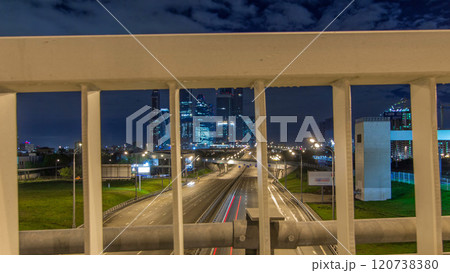 Skyscrapers and transport metropolis timelapse hyperlapse, traffic and lights of cars on multi-lane highways and road junction 120738380