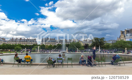 People relaxing in Tuileries Palace open air park near museum timelapse hyperlapse. Paris, France 120738529
