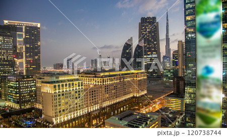 Downtown Dubai towers day to night timelapse. Aerial view of Sheikh Zayed road with skyscrapers after sunset. Downtown Dubai towers day to night timelapse. Aerial view of Sheikh Zayed road with skyscrapers after sunset. 120738744