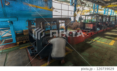 Conveyor assembly stage the body of tractor at big industrial factory timelapse 120739029