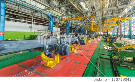Conveyor assembly stage the body of tractor at big industrial factory timelapse Conveyor assembly stage the body of tractor at big industrial factory timelapse 120739042