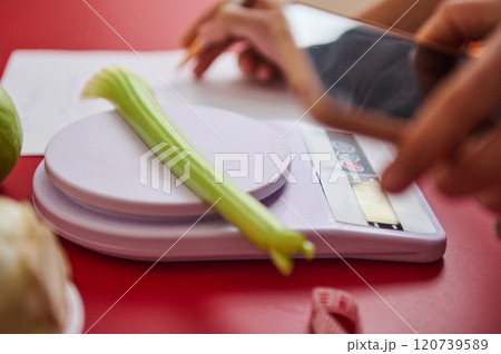 Celery on digital scale with focus on healthy eating 120739589