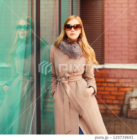 Portrait beautiful elegant blonde woman wearing a coat jacket and sunglasses in city Portrait beautiful elegant blonde woman wearing a coat jacket and sunglasses in city 120739691