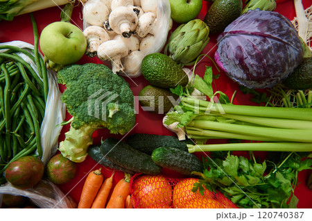 Fresh assorted vegetables on a vibrant red background Fresh assorted vegetables on a vibrant red background 120740387