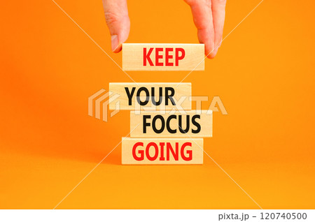 Keep your focus going symbol. Concept words Keep your focus going on beautiful wooden blocks. Beautiful orange table orange background. Business and keep your focus going concept. Copy space. 120740500