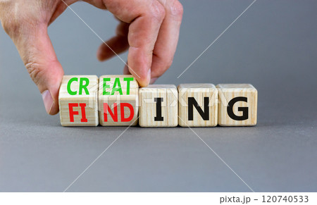 Finding or creating symbol. Businessman turns wooden cubes and changes words Finding to Creating. Beautiful grey table grey background copy space. Business creating or finding concept. 120740533