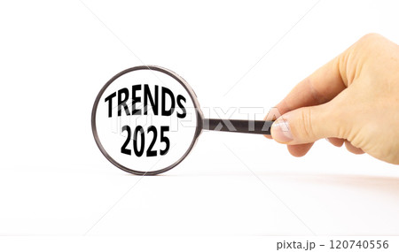 Planning trends 2025 new year symbol. Concept words Trends 2025 on beautiful white paper in magnifying glass. Beautiful white paper background. Business trends 2025 new year concept. Copy space. Planning trends 2025 new year symbol. Concept words Trends 2025 on beautiful white paper in magnifying glass. Beautiful white paper background. Business trends 2025 new year concept. Copy space. 120740556