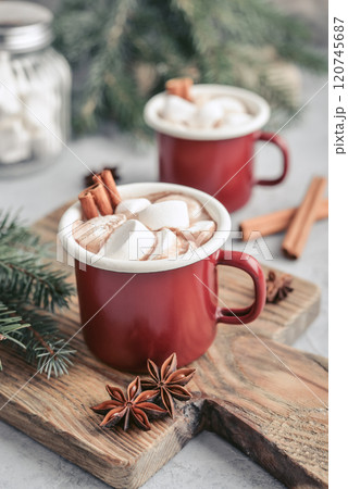 Two red enamel mugs with hot chocolate 120745687