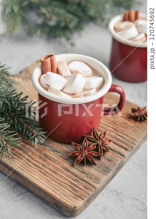 Two red enamel mugs with hot chocolate 120745692