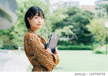 キャンパスを背景にした笑顔の大学生　 120746726