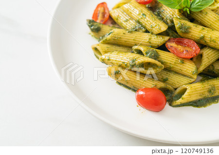 penne pasta with pesto sauce and tomatoes penne pasta with pesto sauce and tomatoes 120749136