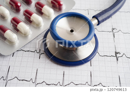 Stethoscope on electrocardiogram ECG with capsule drug, heart wave, heart attack, cardiogram report. 120749613
