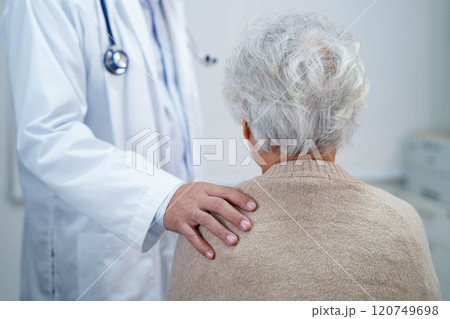 Doctor taking care, help and encourage Asian elder senior woman patient in clinic hospital. 120749698