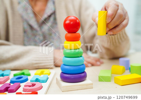 Asian elderly woman playing game. Asian elderly woman playing game. 120749699