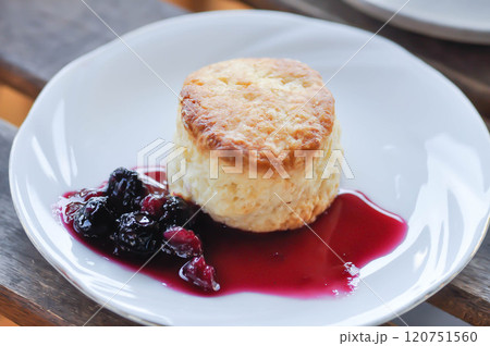 scone with berry sauce or berry dressing scone with berry sauce or berry dressing 120751560