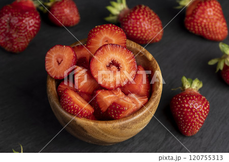 several pieces of red sweet strawberries in close-up 120755313