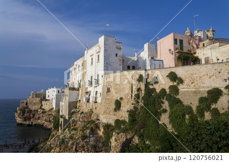 Traditional houses on dramatic cliffs rising from Adriatic sea in Polignano a Mare, Italy Traditional houses on dramatic cliffs rising from Adriatic sea in Polignano a Mare, Italy 120756021