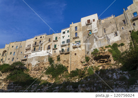 Traditional houses on dramatic cliffs rising from Adriatic sea in Polignano a Mare, Italy 120756024