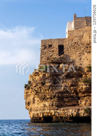 Traditional houses on dramatic cliffs rising from Adriatic sea in Polignano a Mare, Italy 120756026