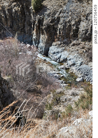Small mountain river of beautiful color with rocky banks and rocky slope Small mountain river of beautiful color with rocky banks and rocky slope 120756459