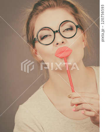 Happy woman holding fake lips on stick 120756593