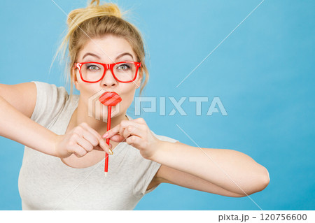 Happy woman holding fake lips on stick 120756600