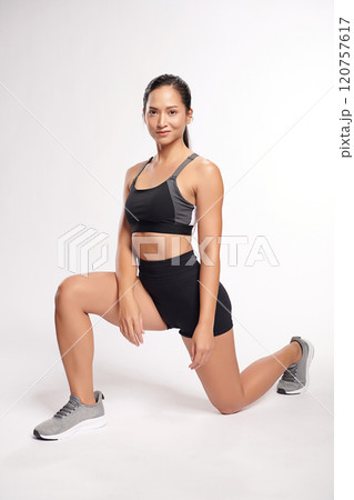 an asian woman is working out wearing the sport exercise suit with white background, an asian woman is working out wearing the sport exercise suit with white background, 120757617