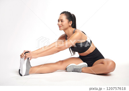 an asian woman is  working out  wearing the sport exercise suit with white background, 120757618