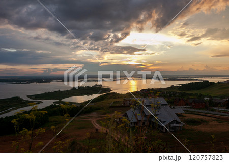 Sunset over tranquil waters and rolling hills at Sviyazhsk revealing natures serene beauty Sunset over tranquil waters and rolling hills at Sviyazhsk revealing natures serene beauty 120757823