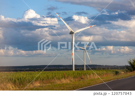 Wind turbines stand tall against a stunning sky in rural landscape highlighting renewable energy efforts 120757843